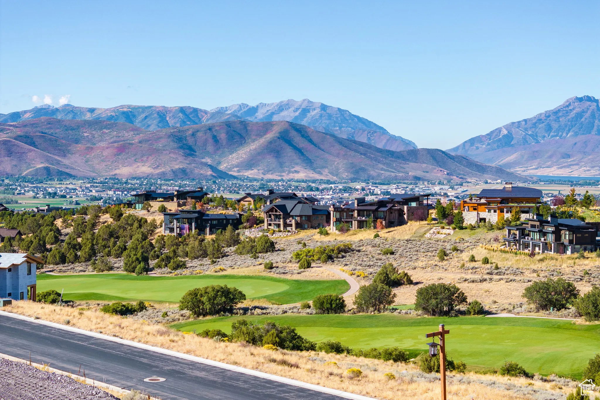 View of mountain background featuring a golf course
