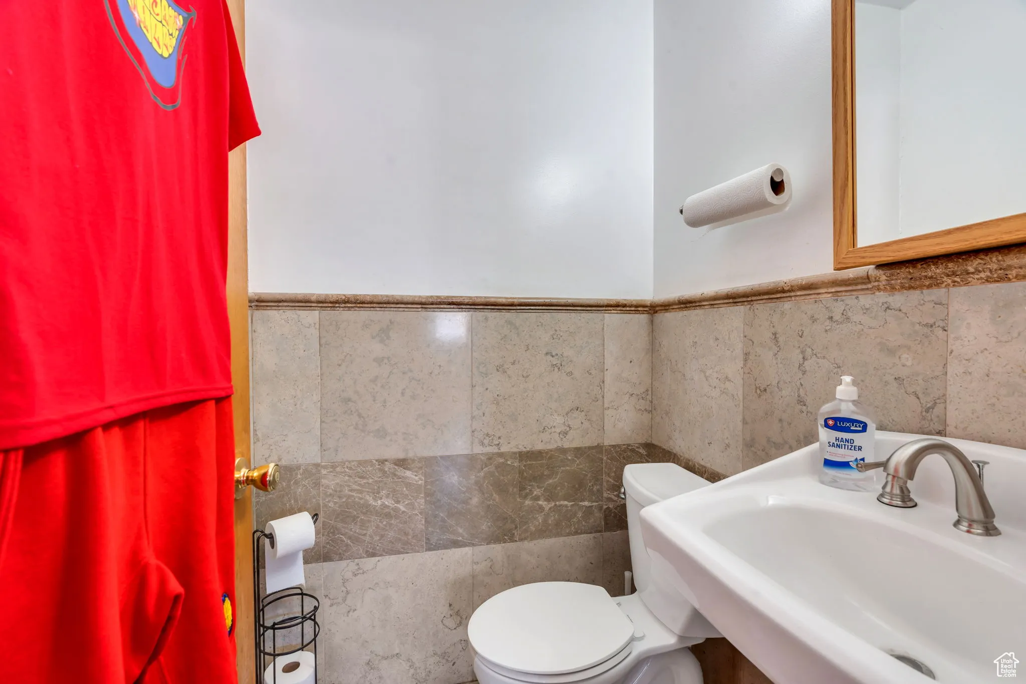 Bathroom featuring tile walls and wainscoting