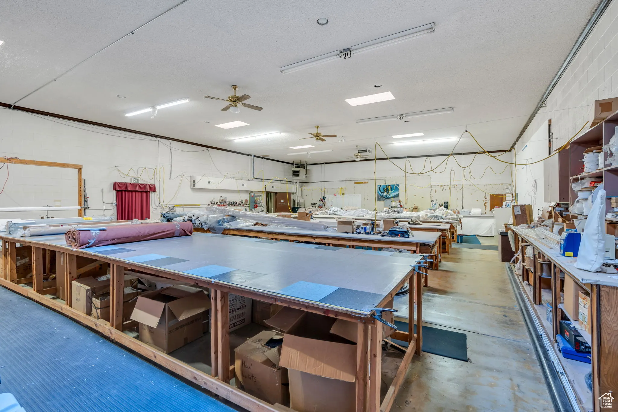 Interior space featuring ceiling fan and a textured ceiling
