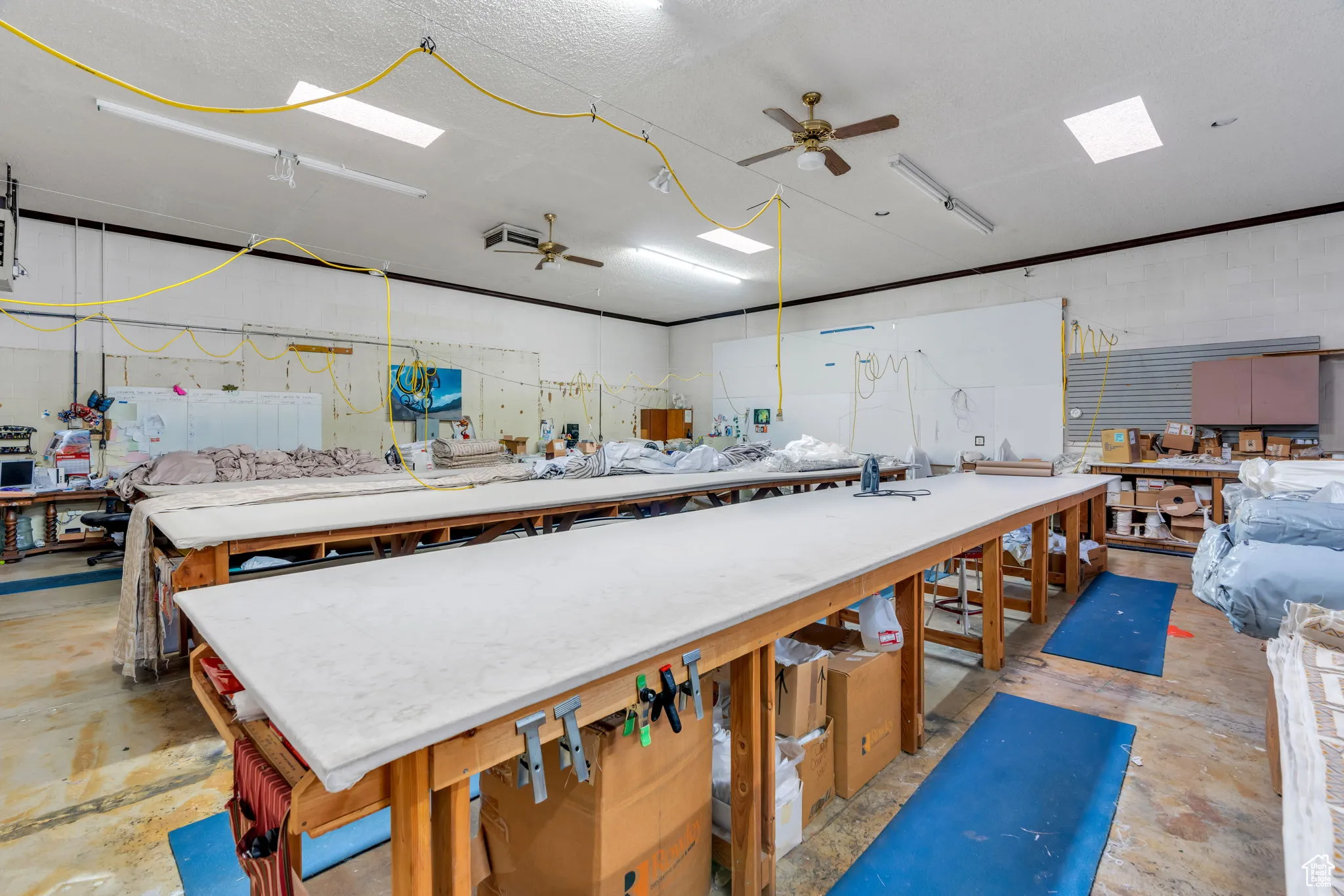 Kitchen featuring ceiling fan, open floor plan, and light countertops