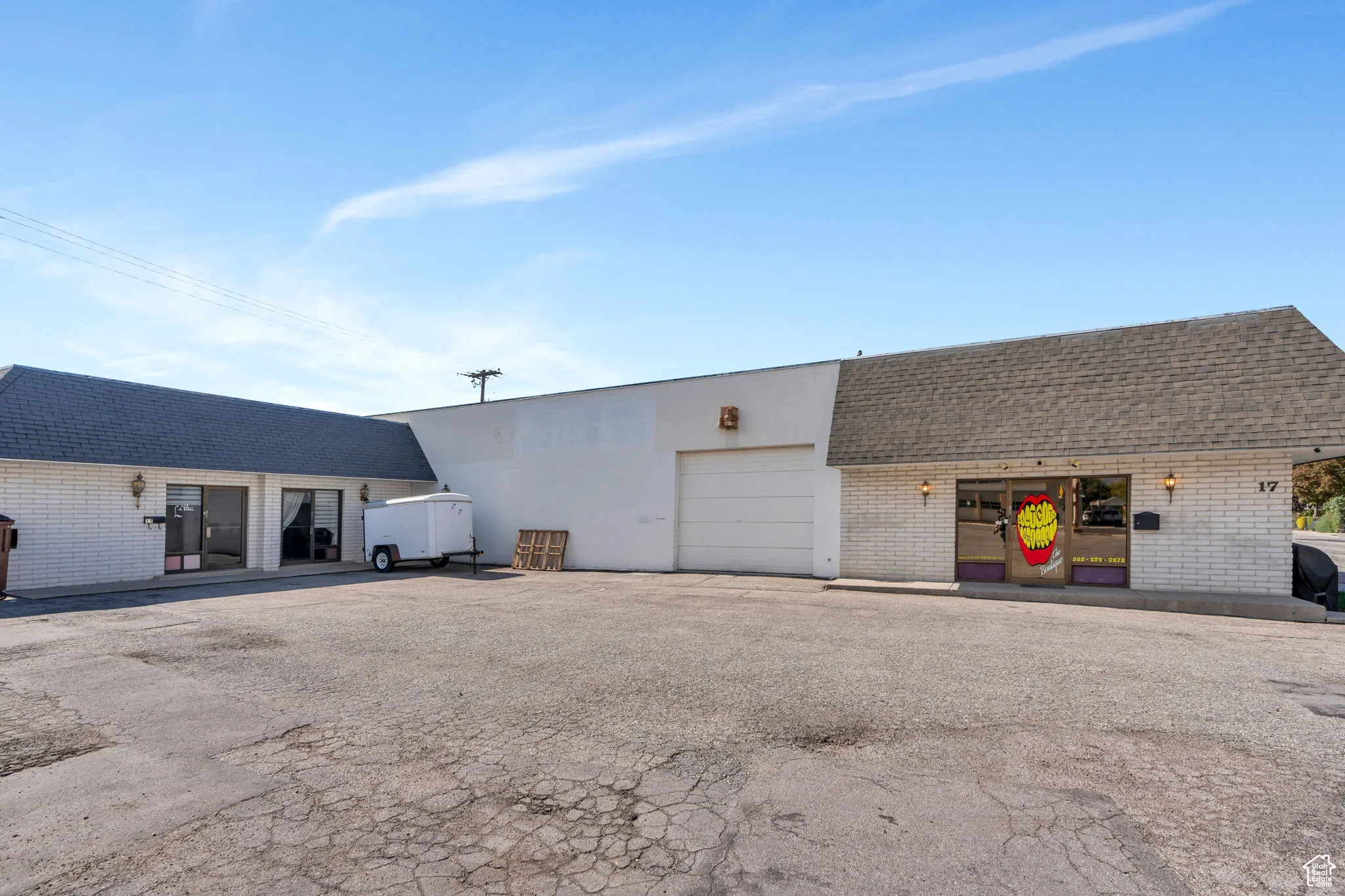 View of front of property with brick siding and asphalt driveway