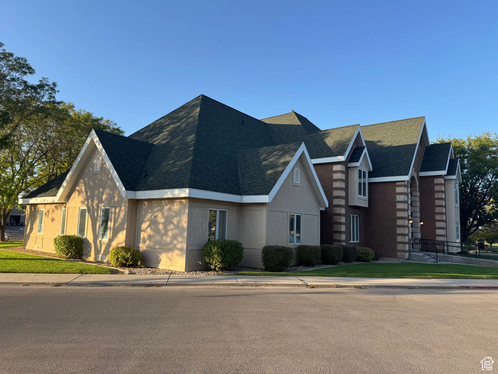 View of side featuring roof with shingles