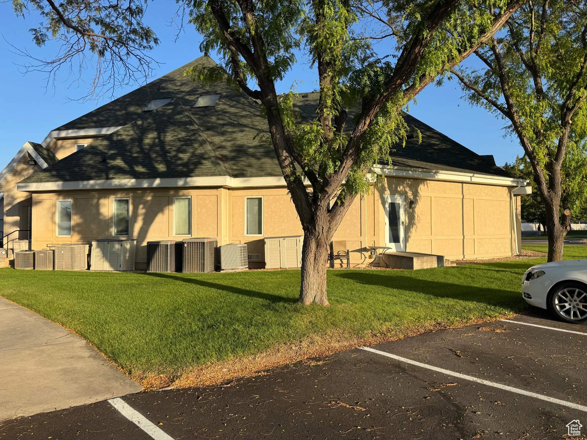View of building exterior with uncovered parking