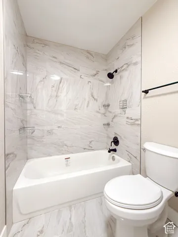 Full bathroom featuring bathing tub / shower combination and toilet