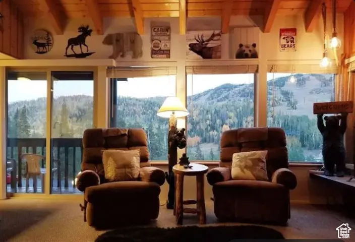 Sunroom featuring beamed ceiling