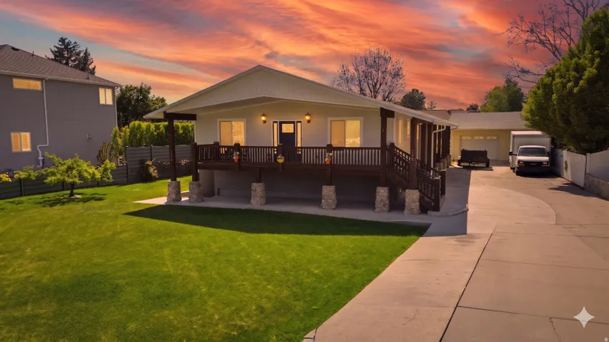Ranch-style exterior with a covered porch and stone-clad columns