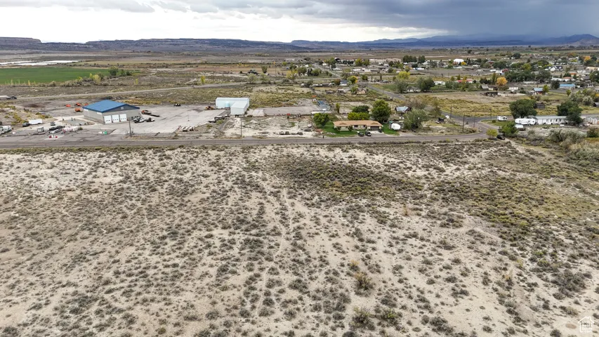 Aerial view of sparsely populated area featuring a mountain backdrop and a desert landscape