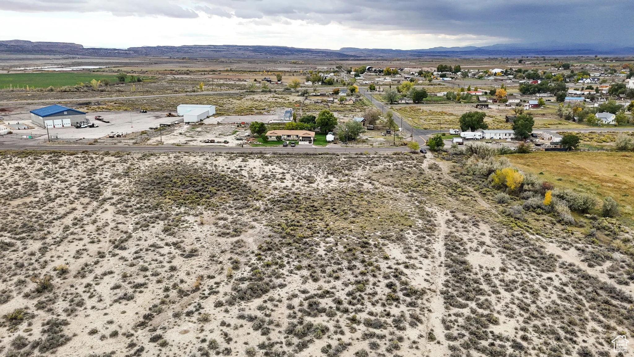 Overview of rural landscape with a mountain backdrop and a desert landscape