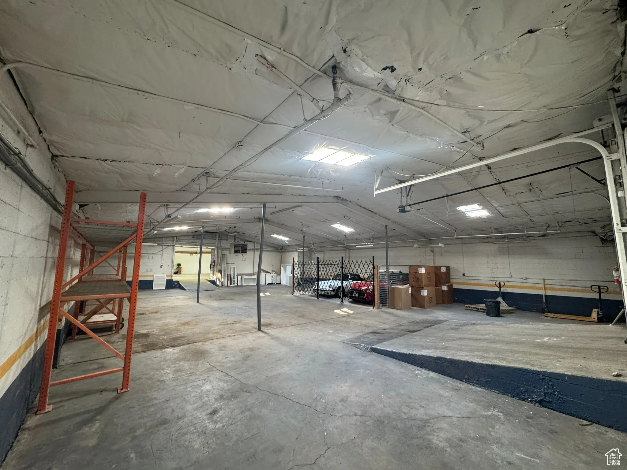 Garage featuring concrete block wall