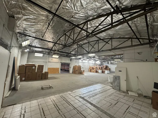 Misc room featuring metal wall and high vaulted ceiling