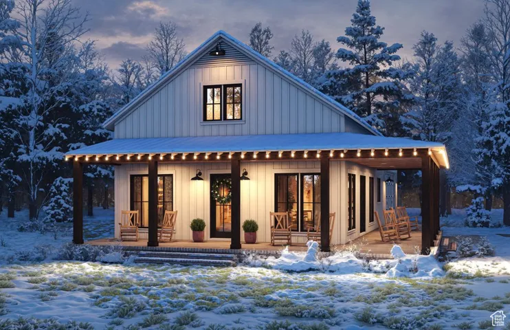 Snow covered house featuring board and batten siding, covered porch, and french doors