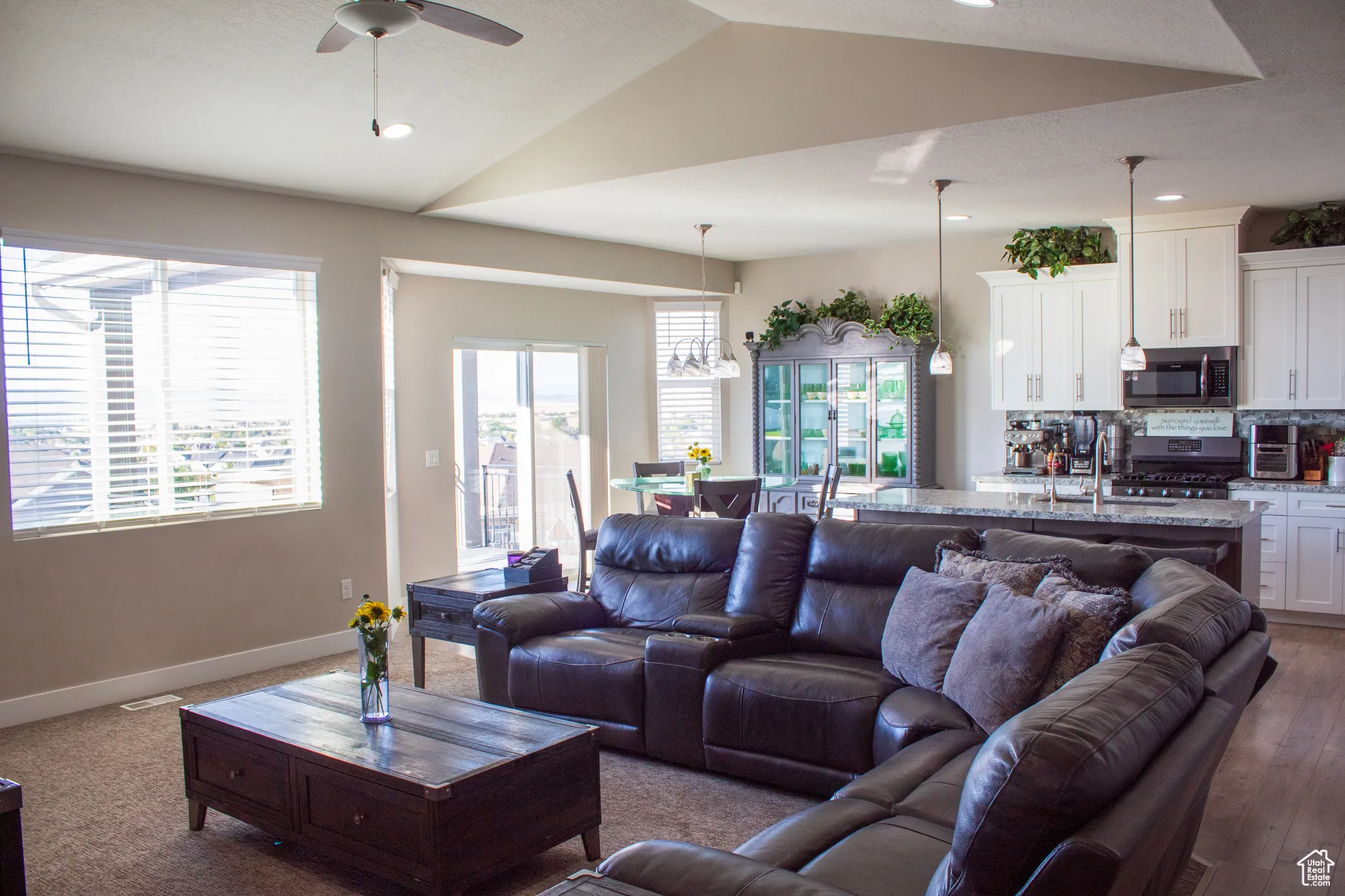 Living room featuring ceiling fan, recessed lighting, lofted ceiling, and dark carpet