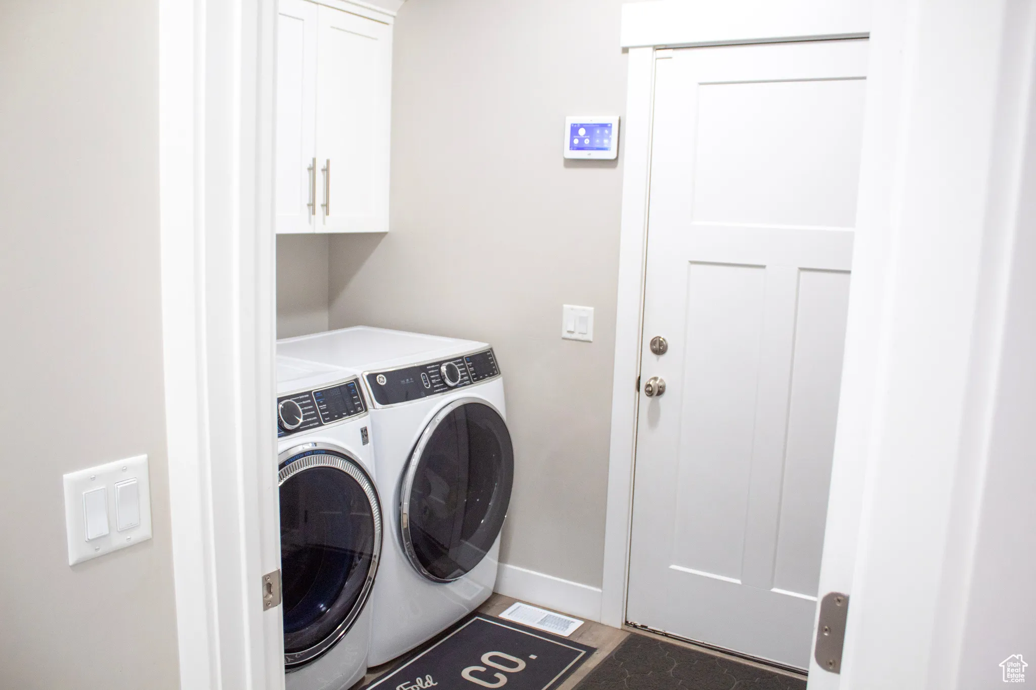 Laundry area with washing machine and clothes dryer and cabinet space