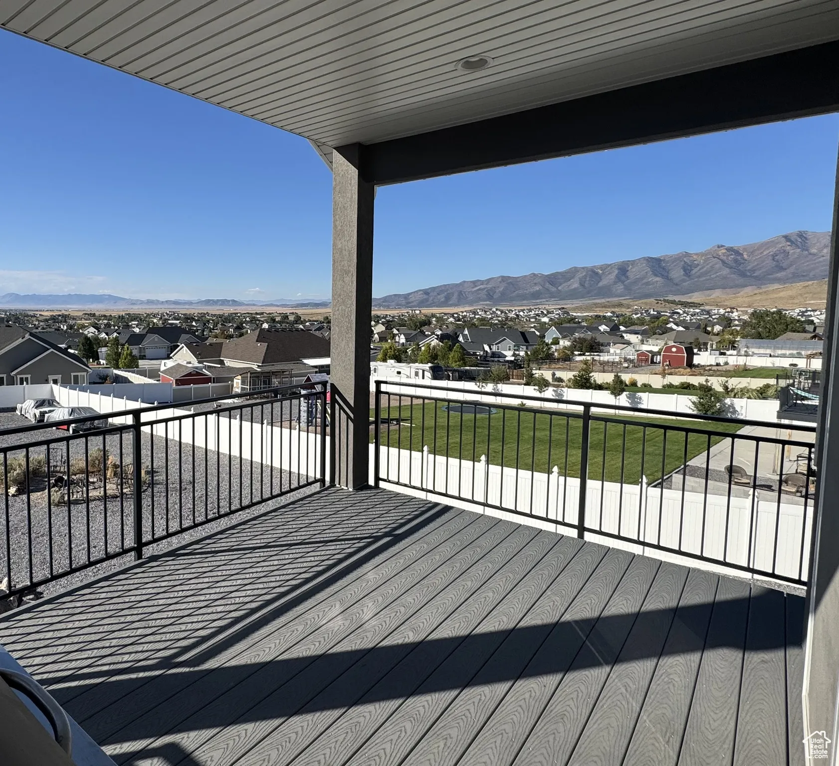 Wooden deck with a residential view and a mountain view