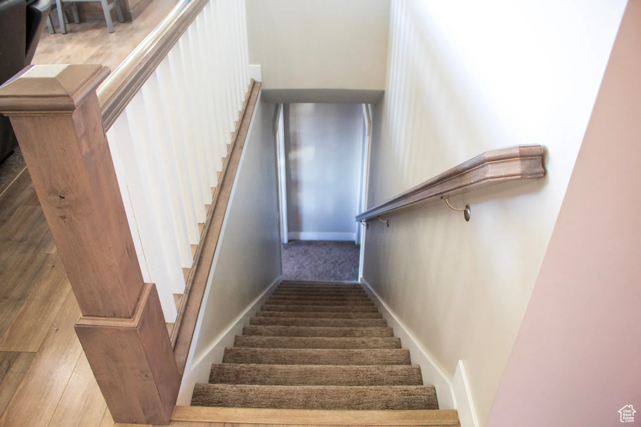 Stairs with carpet flooring and baseboards