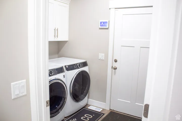 Laundry area with washing machine and clothes dryer and cabinet space