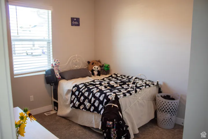 Carpeted bedroom with baseboards