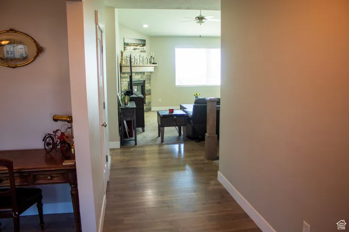 Corridor featuring dark wood-style flooring and a desk
