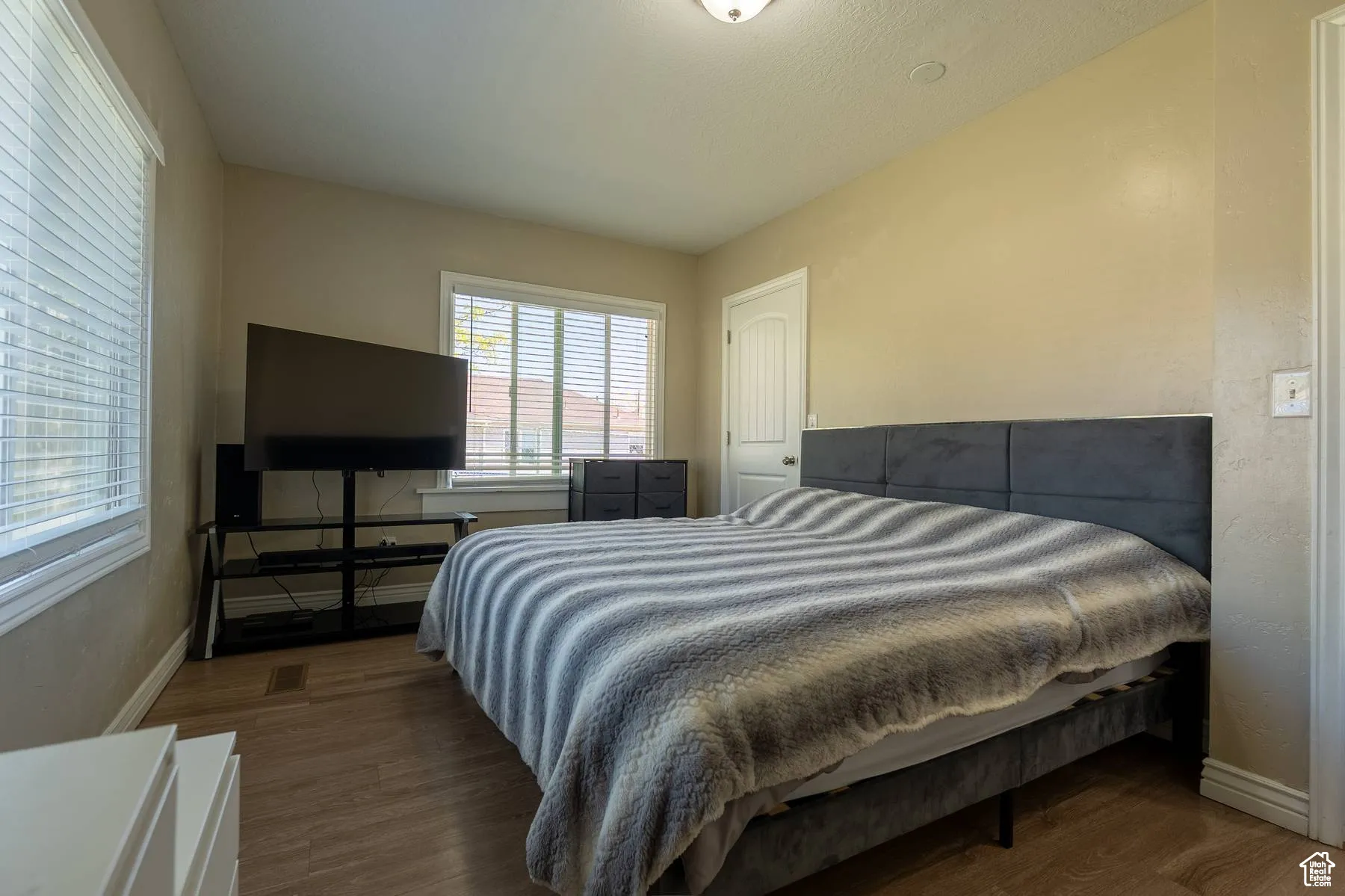 Bedroom featuring baseboards and wood finished floors