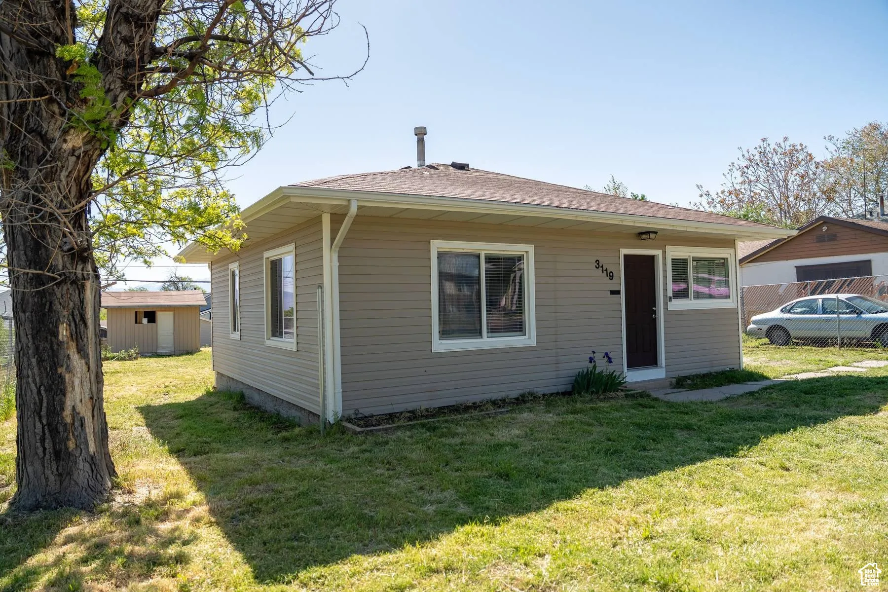 Bungalow-style house with a front yard and a shingled roof