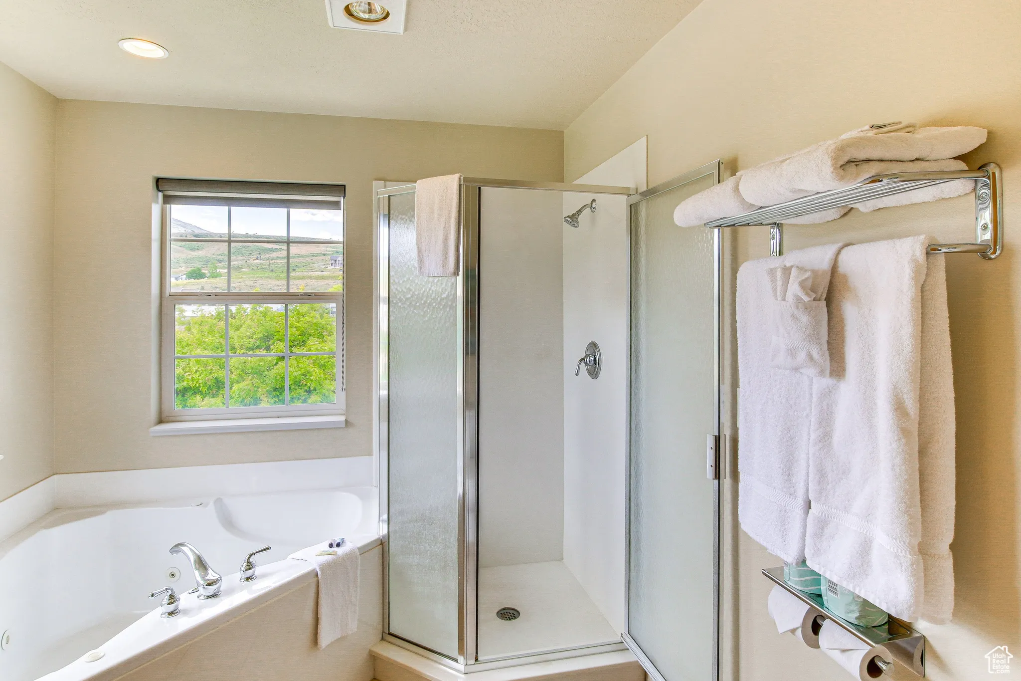 Full bath with a shower stall and a bath