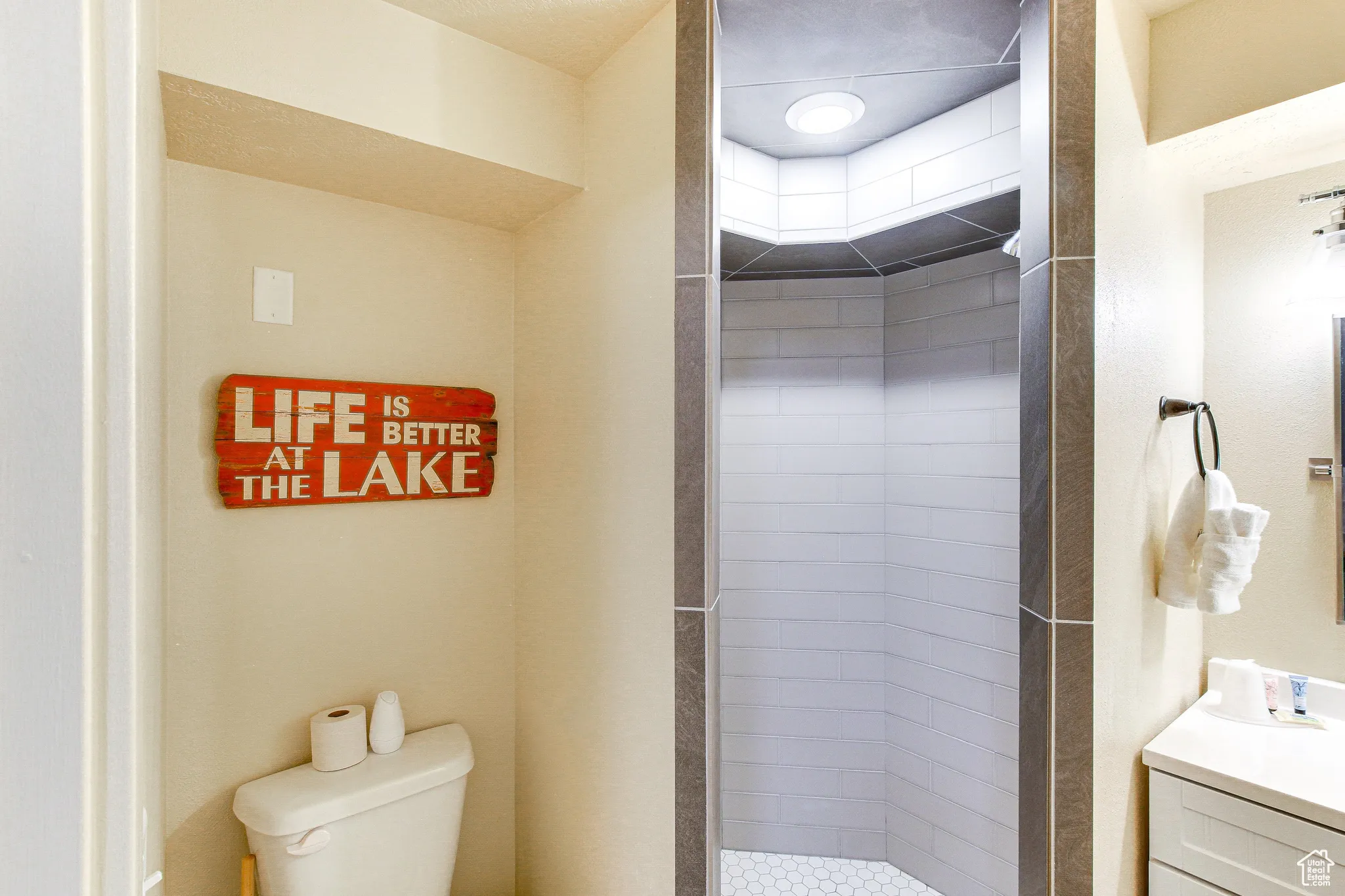 Bathroom featuring vanity and a stall shower