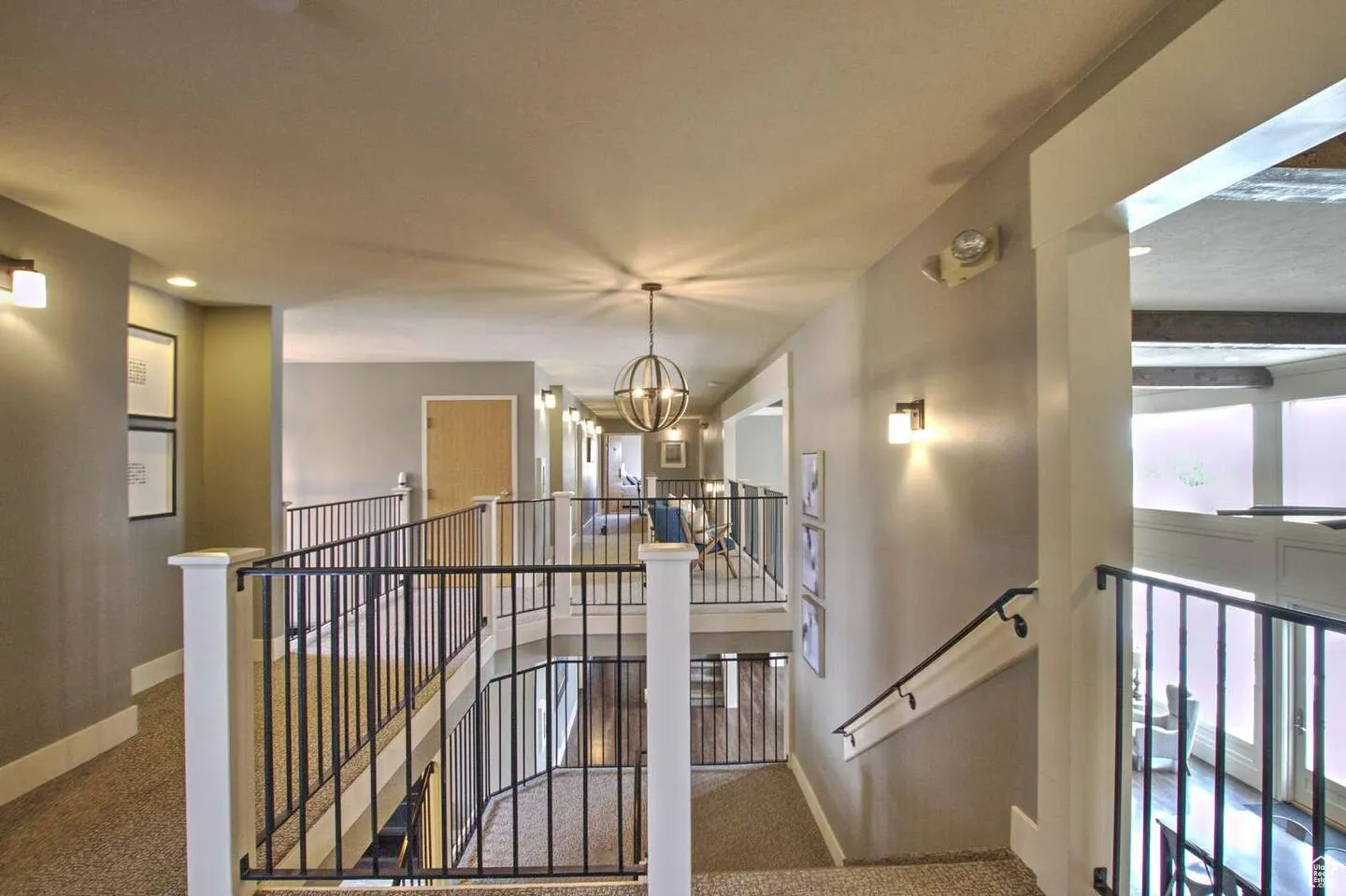 Corridor featuring an upstairs landing, carpet, a chandelier, and recessed lighting