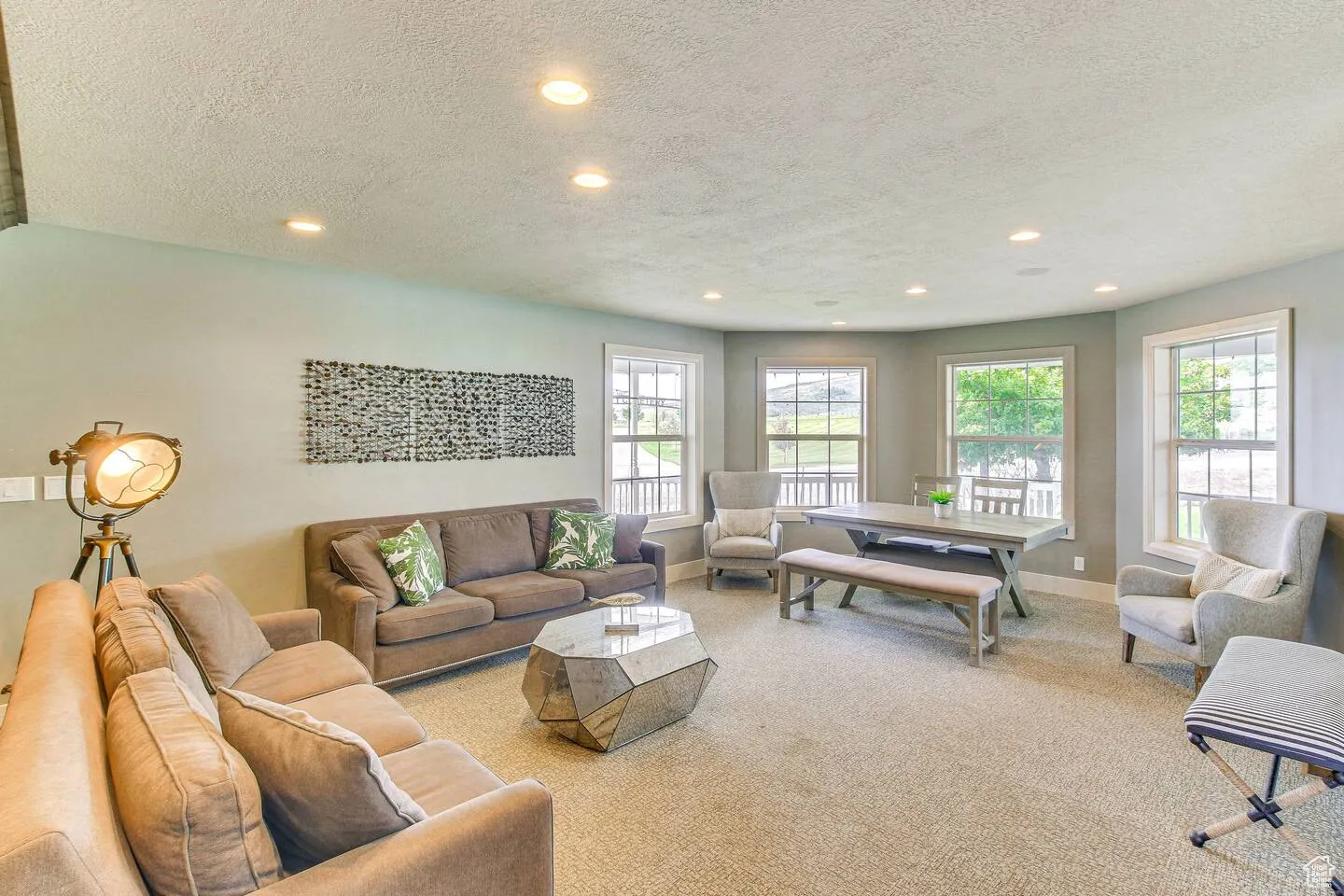Living area featuring recessed lighting, carpet floors, and a textured ceiling