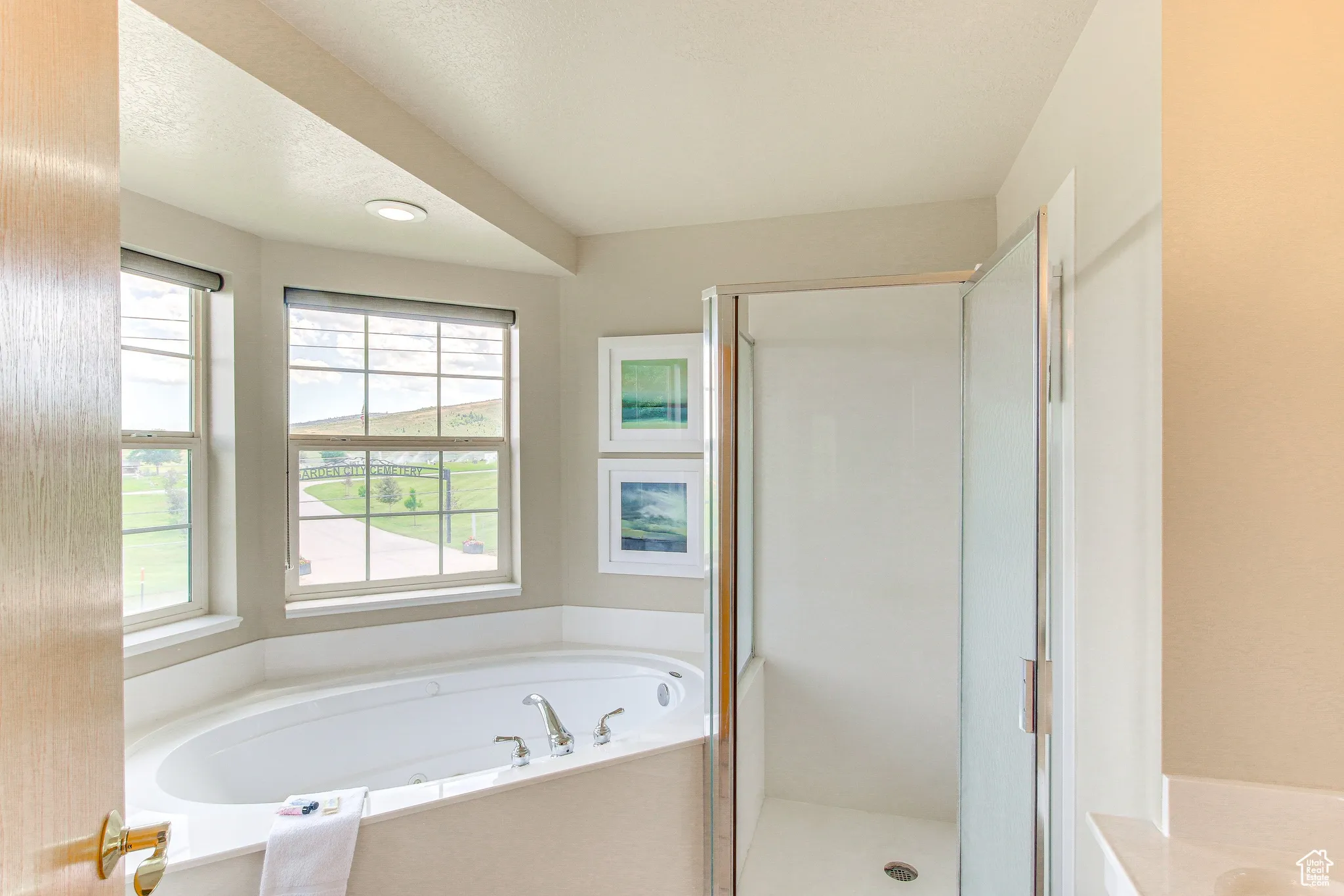 Full bathroom featuring a stall shower, a garden tub, and recessed lighting