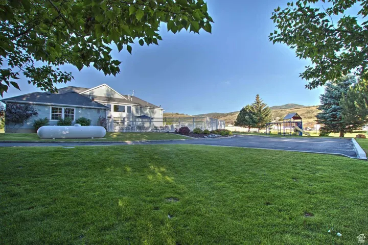 View of home's community featuring a lawn and a playground