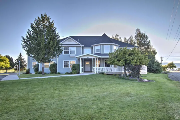Victorian home with covered porch and a front lawn
