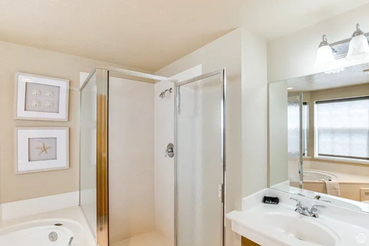 Full bath featuring a shower stall and a garden tub