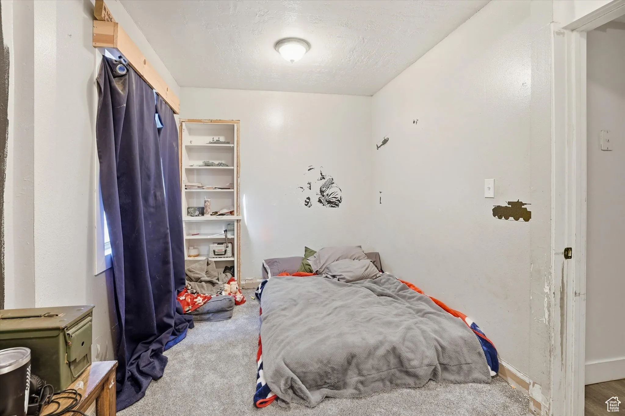 Carpeted bedroom featuring a textured ceiling