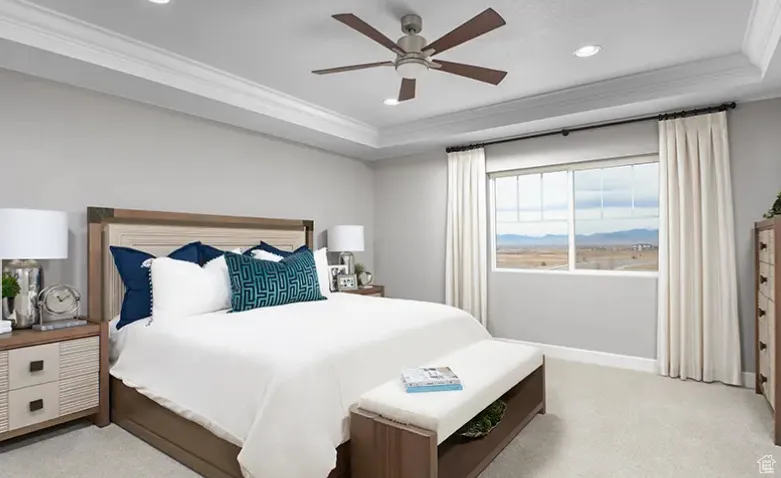 Bedroom with a tray ceiling, light carpet, crown molding, a ceiling fan, and recessed lighting