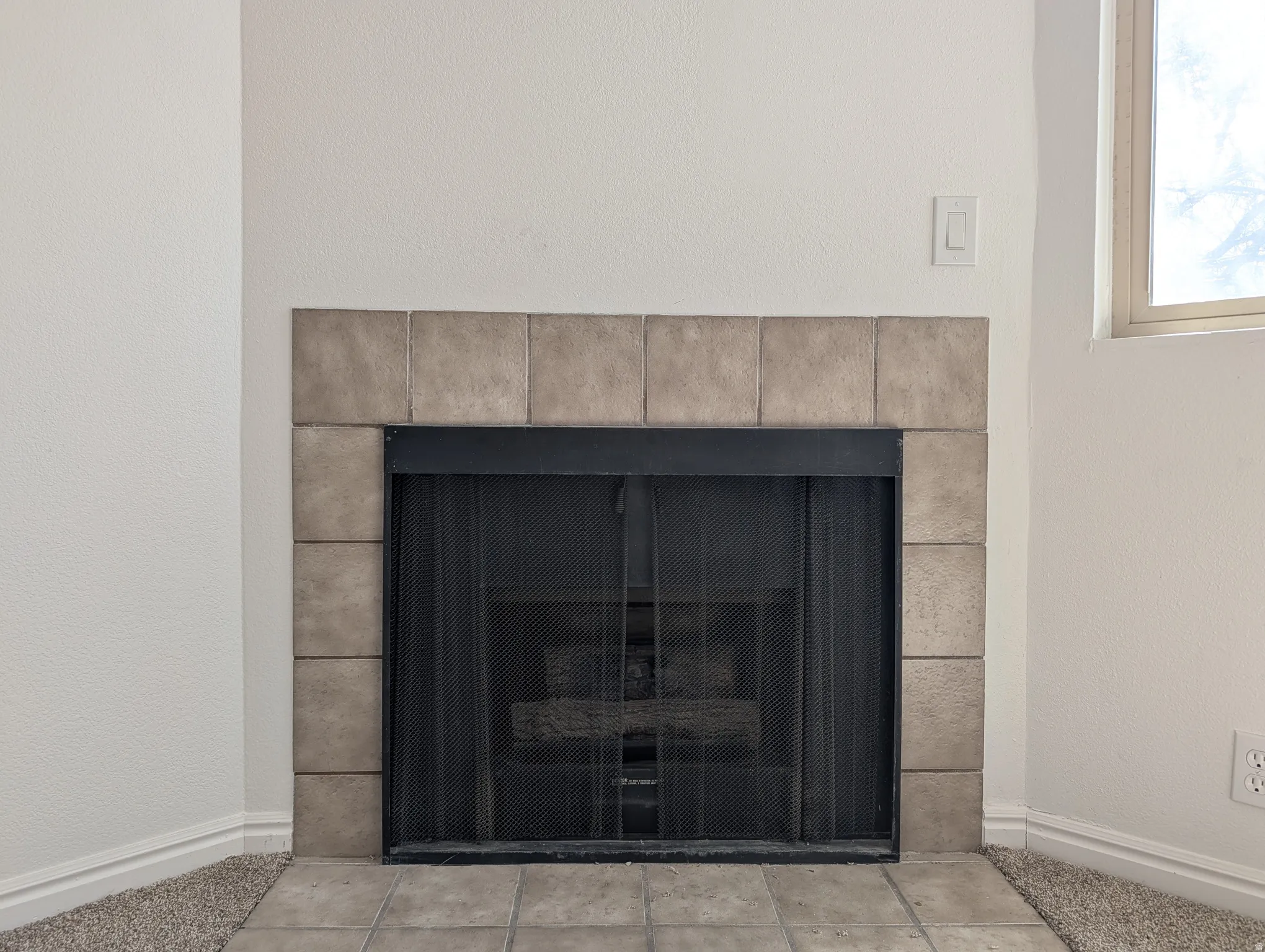 Detailed view of baseboards and a textured wall
