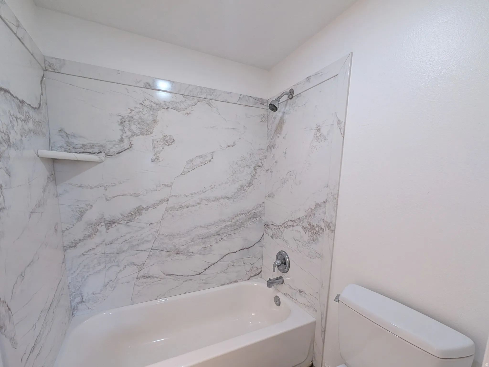 Full bathroom with toilet and washtub / shower combination