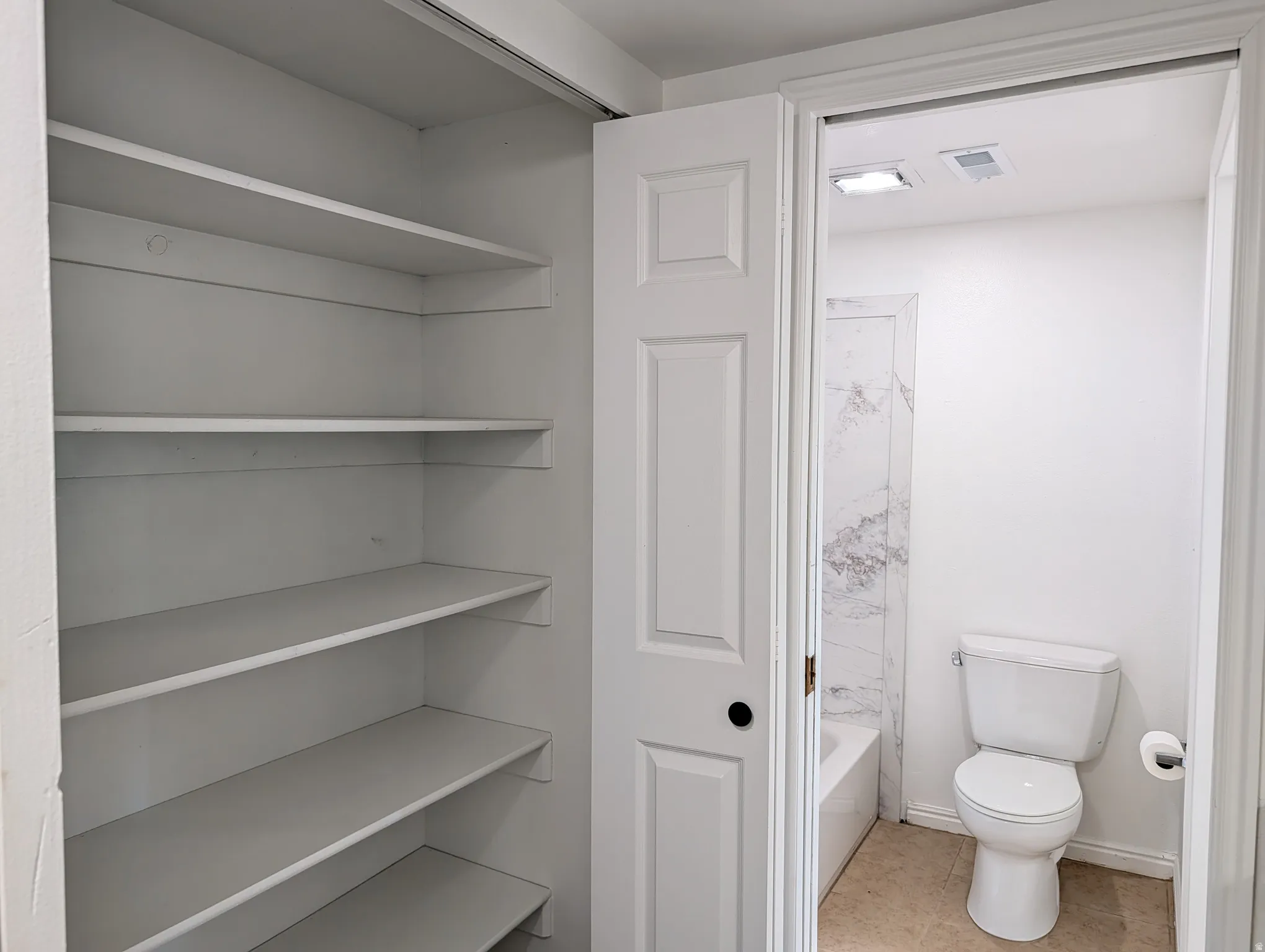 Full bathroom with a closet and light tile patterned floors