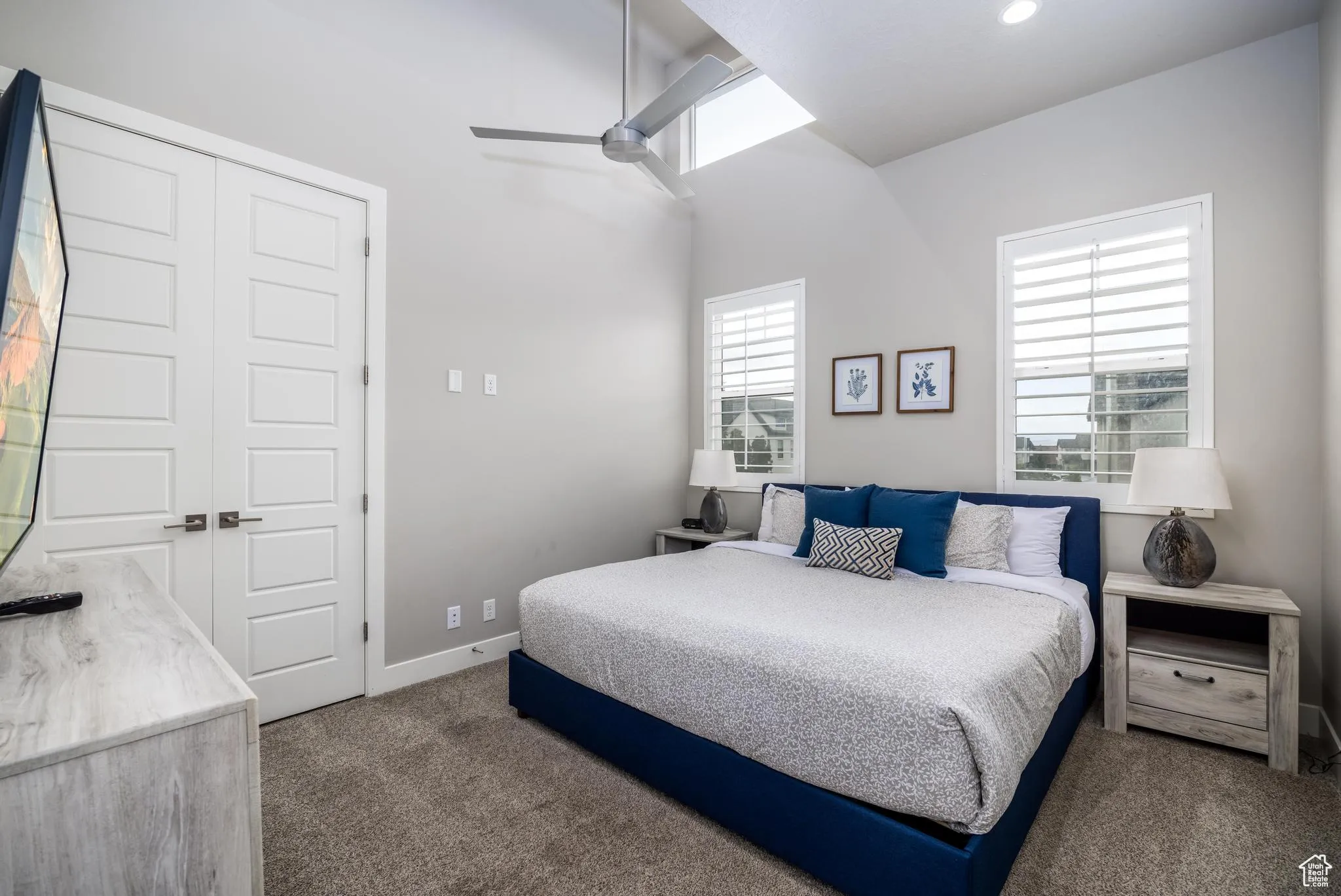Bedroom with dark carpet, a closet, and ceiling fan
