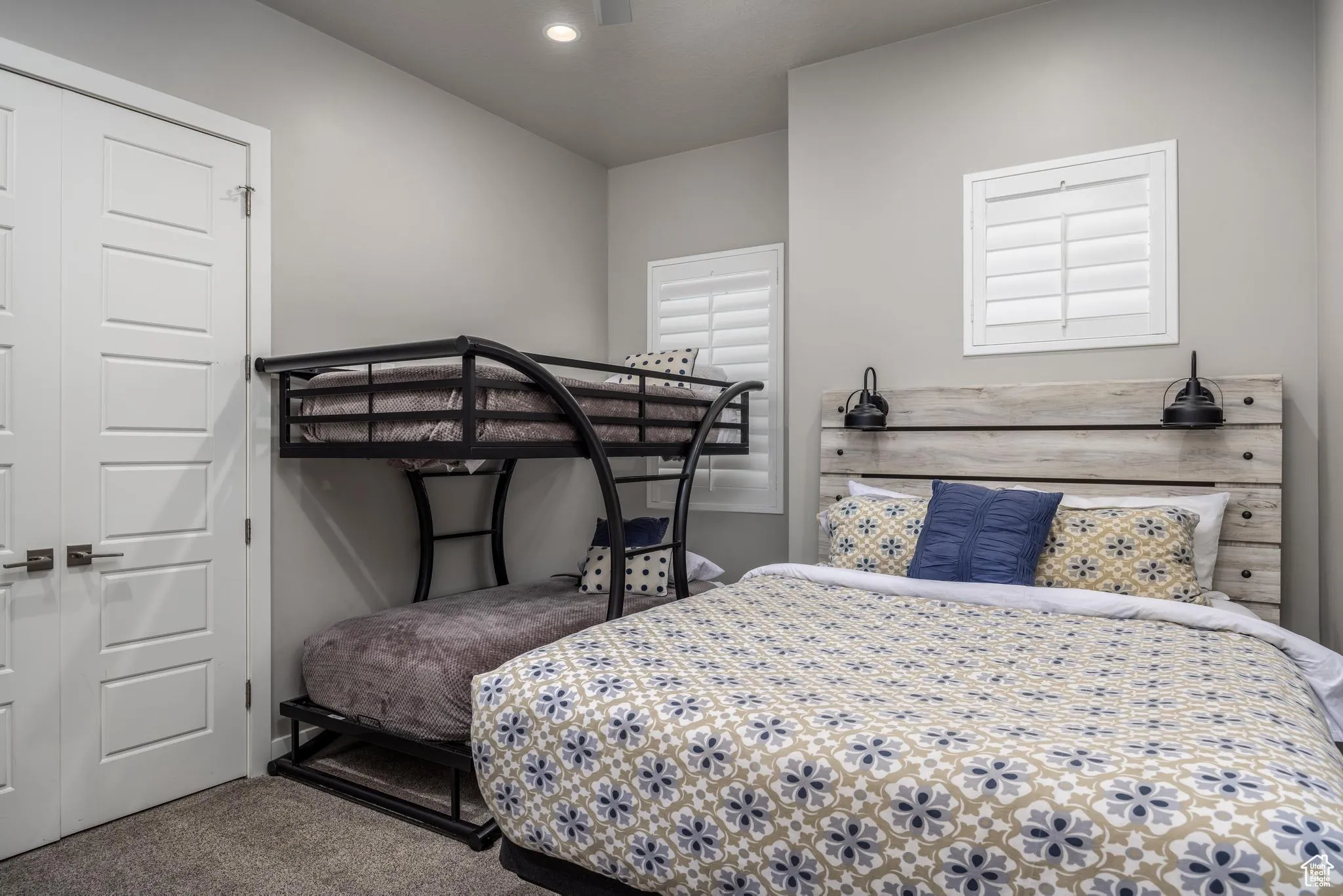 Bedroom with carpet flooring, a closet, and a ceiling fan