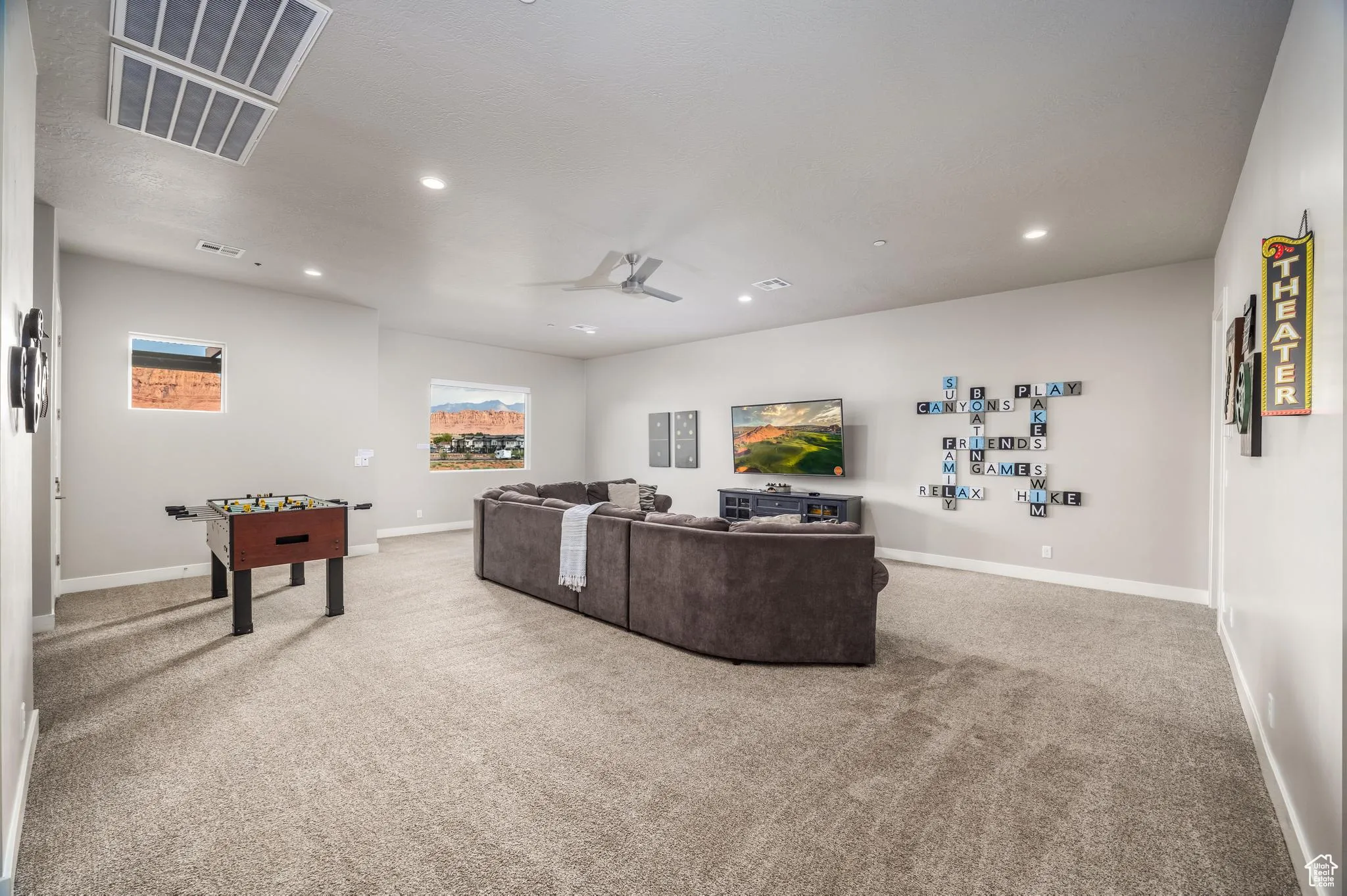 Living room featuring light carpet, a ceiling fan, and recessed lighting