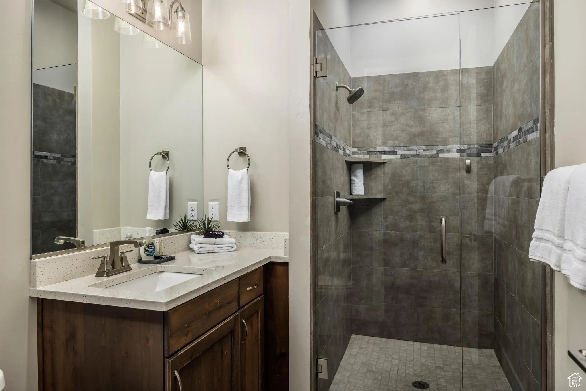 Bathroom with vanity and a stall shower