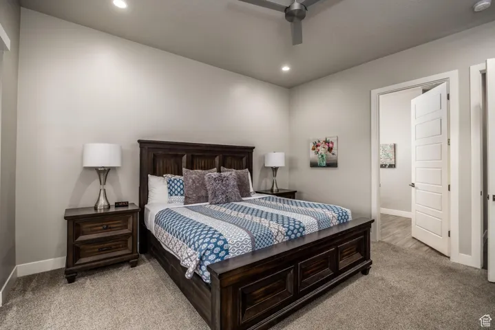 Bedroom featuring light carpet, recessed lighting, and a ceiling fan
