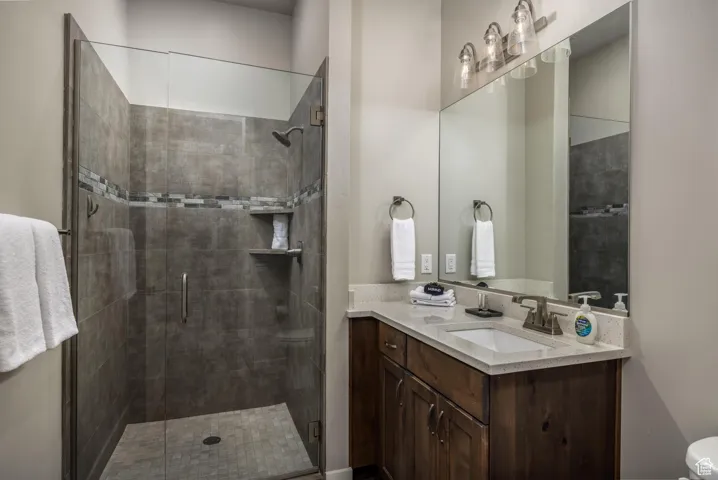 Bathroom featuring vanity and a shower stall