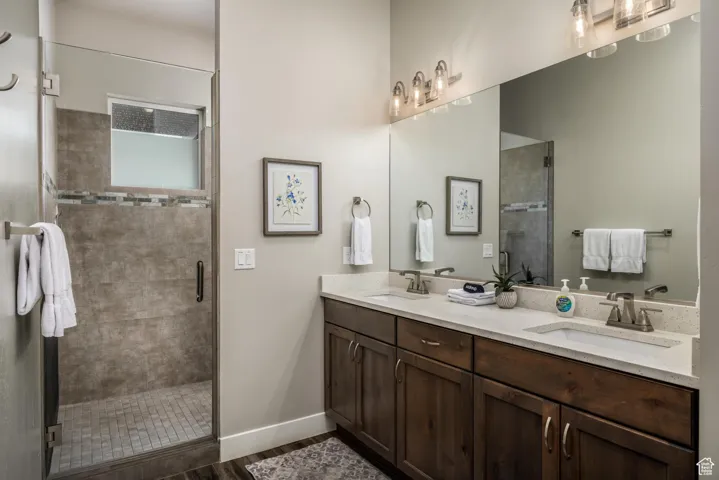 Bathroom with a shower stall and double vanity
