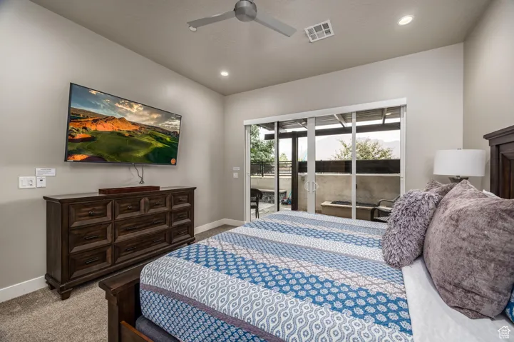 Bedroom with access to exterior, light colored carpet, ceiling fan, and recessed lighting