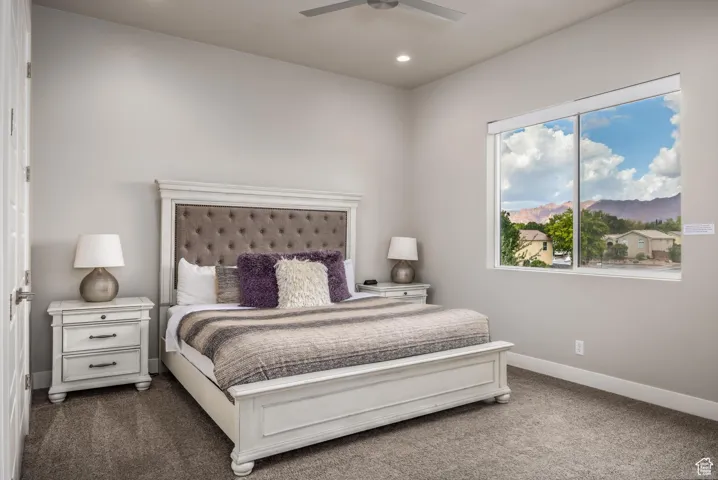 Carpeted bedroom featuring a mountain view, a ceiling fan, and recessed lighting