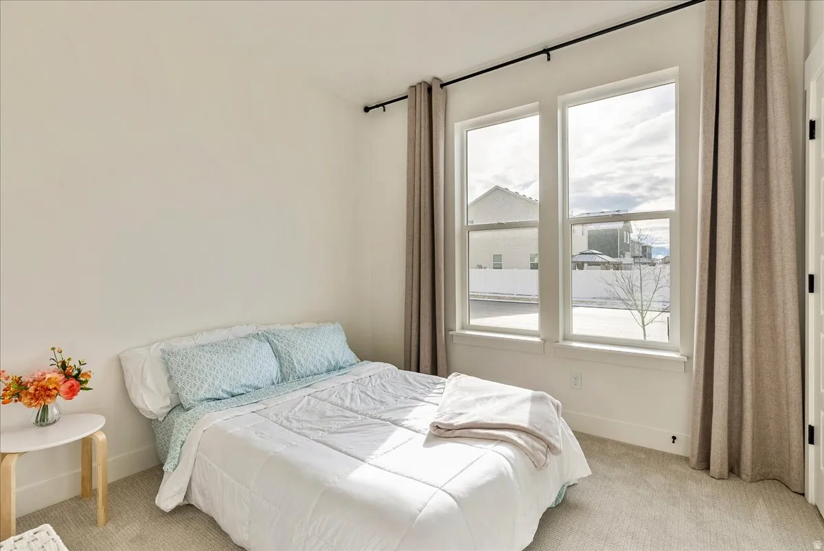 Bedroom with carpet floors and baseboards