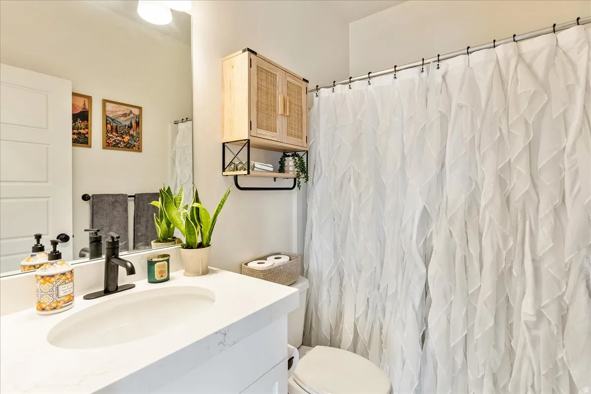 Full bathroom featuring vanity and curtained shower