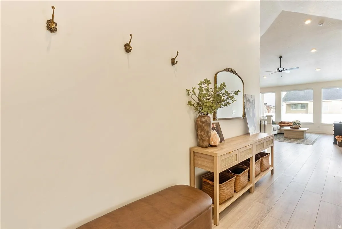 Corridor featuring recessed lighting, wood finished floors, and vaulted ceiling