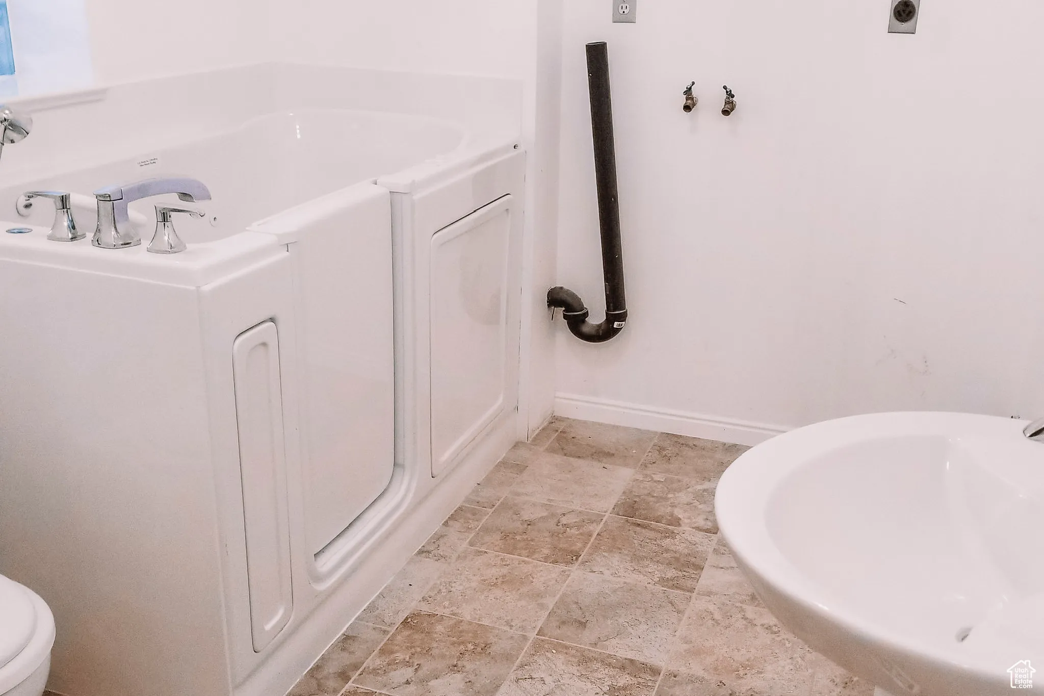 Full bathroom with baseboards and a garden tub